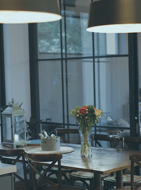 A contemporary dining space illuminated by a curated pendant light